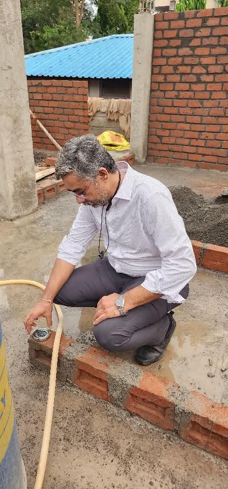 Taking a Vastu compass reading at a construction site