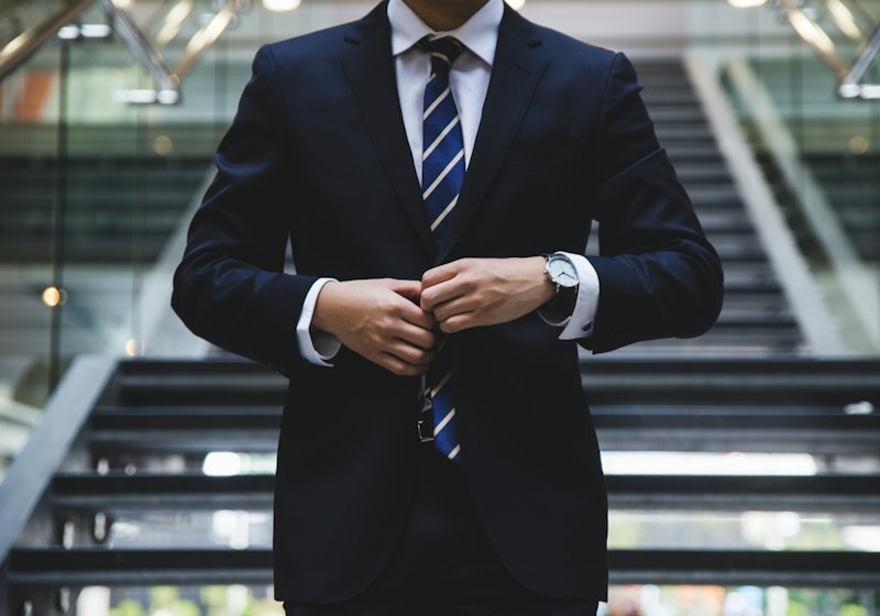 Professional in a suit buttoning his jacket